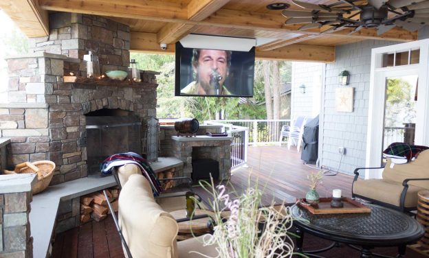 Outdoor entertainment area complete with a 65-inch, motorized, flip-down, high-definition screen and home-theater surround system.
